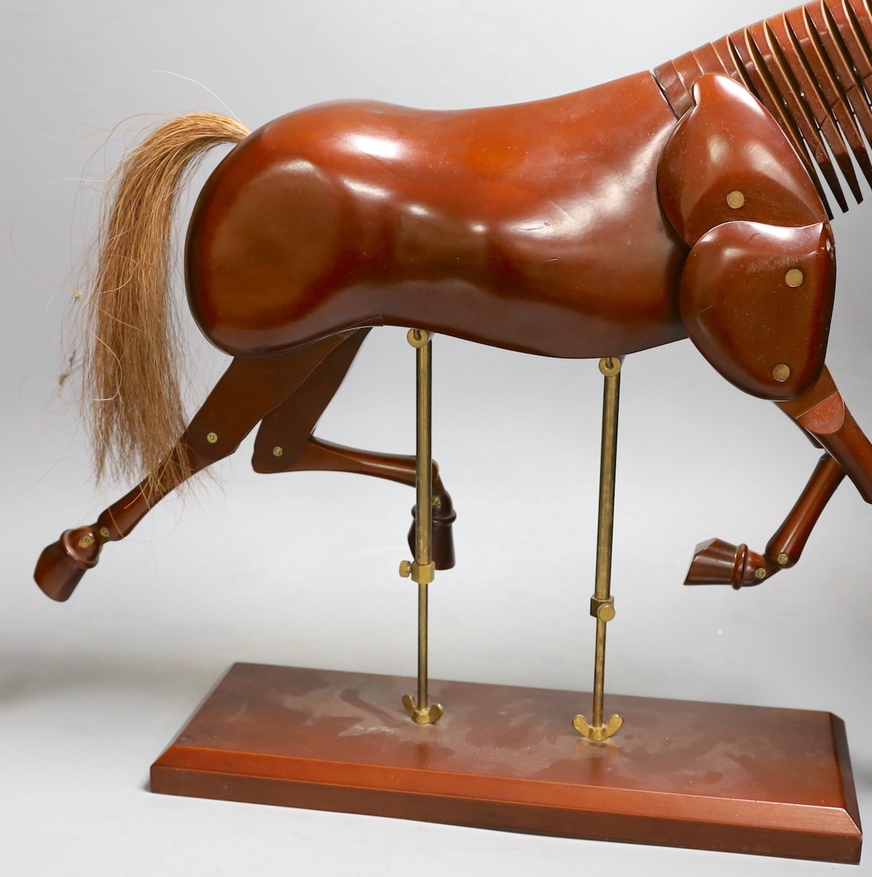 A modern artist's wooden articulated model of a horse, on stand, approx 51 cms wide x 46cms high